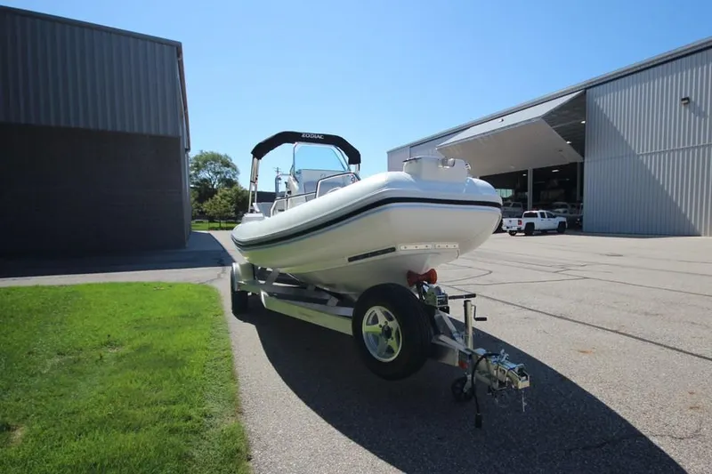 Slide: The Image of 2025 Zodiac Medline 6.8 NEO boat on trailer, parked outdoors, sunny day. - 2