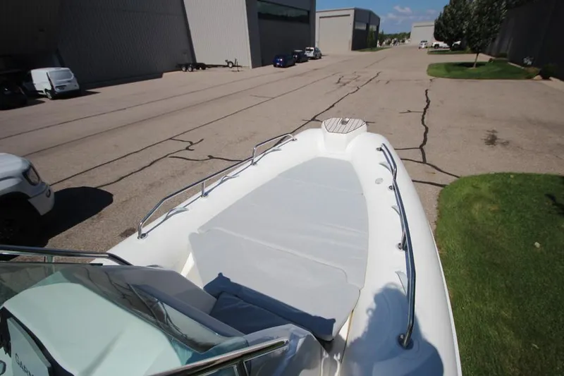 Slide: The Image of 2025 Zodiac Medline 6.8 NEO boat interior with seating and engine view. - 24