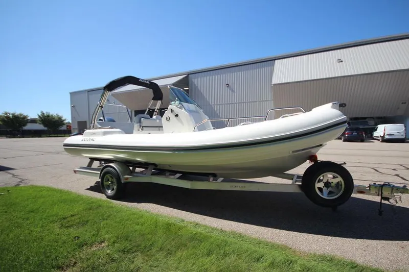 Slide: The Image of 2025 Zodiac Medline 6.8 NEO boat on trailer, parked outdoors, clear sky background. - 3