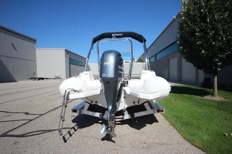 Slide: The Image of 2025 Zodiac Medline 6.8 NEO boat with 200hp engine on trailer, outdoor setting. - 5