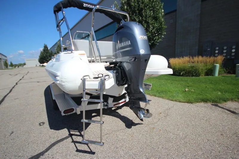 Slide: The Image of 2025 Zodiac Medline 6.8 NEO boat, white interior, outdoor setting, sunny day. - 6