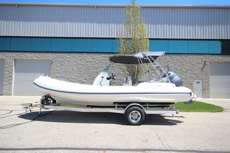 Slide: The Image of 2025 Zodiac Medline 6.8 NEO boat on trailer, parked outside industrial building. - 30
