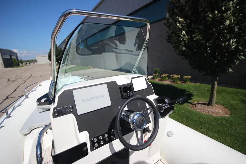 Slide: The Image of 2025 Zodiac Medline 6.8 NEO boat storage compartment with open lid and contents. - 18