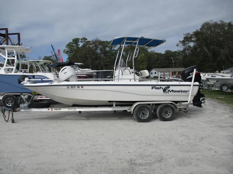 The Image of 2005 Fishmaster 22 boat on trailer, parked outdoors. - 1