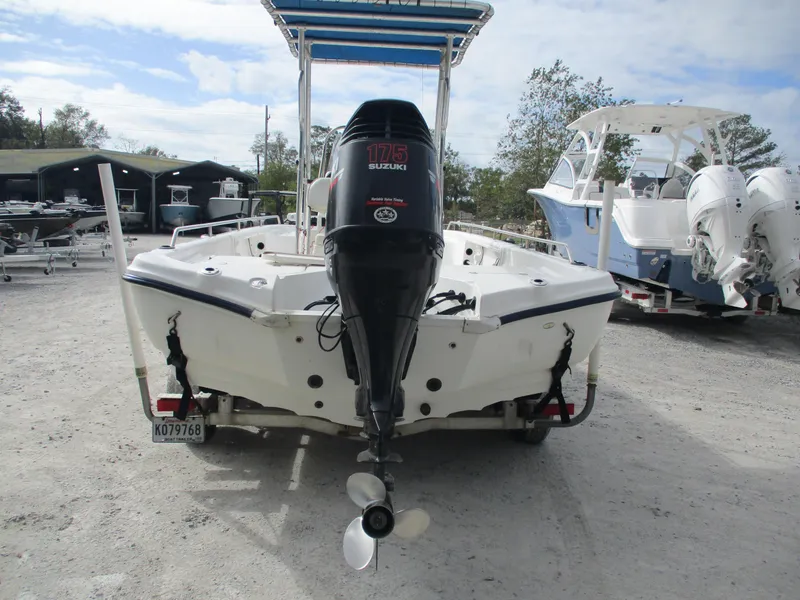 Slide: The Image of 2005 Fishmaster 22 boat with Suzuki outboard motor in a marina. - 2