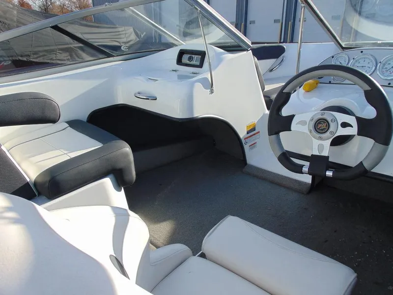 Slide: The Image of Interior of 2015 Caravelle 19EBo boat with steering wheel and seating. - 10