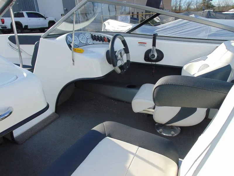 Slide: The Image of 2015 Caravelle 19EBo boat interior with steering wheel and seating. - 11