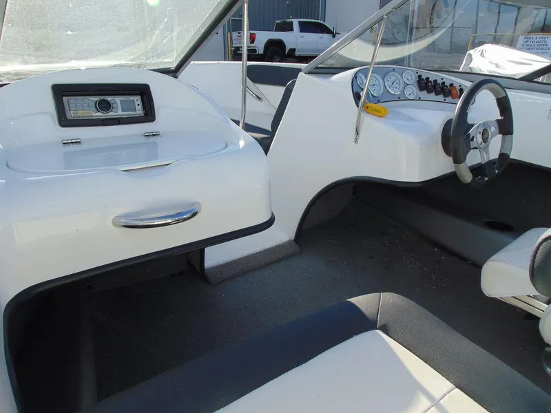 Slide: The Image of Interior of 2015 Caravelle 19EBo boat with steering wheel and dashboard controls. - 12