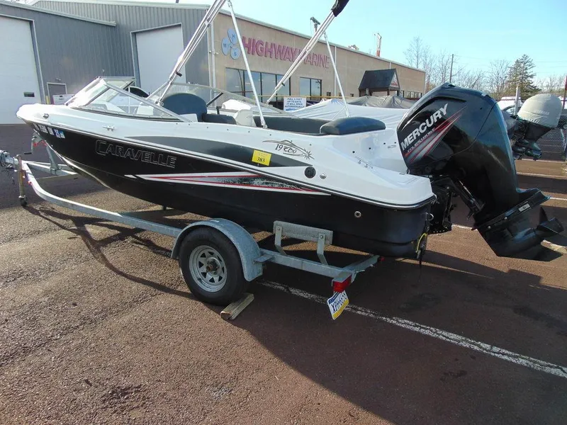 Slide: The Image of 2015 Caravelle 19EBo boat on trailer with Mercury outboard motor. - 2