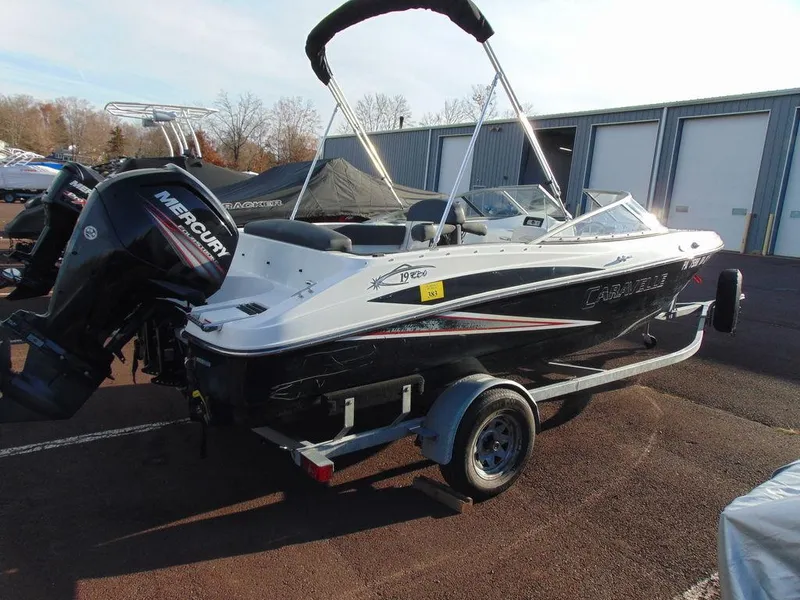 Slide: The Image of 2015 Caravelle 19EBo boat with Mercury outboard motor, parked on trailer. - 3