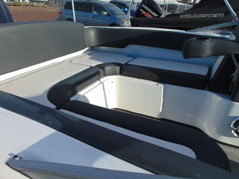 Slide: The Image of 2015 Caravelle 19EBo boat interior with cushioned seating and storage area. - 6