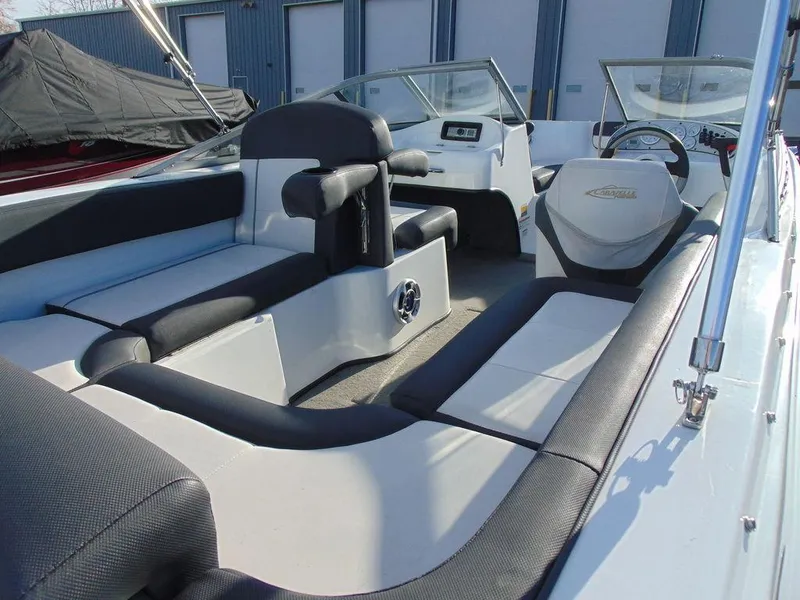 Slide: The Image of 2015 Caravelle 19EBo boat interior with black and white seating, steering wheel, and dashboard. - 7
