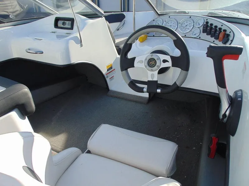 Slide: The Image of Interior of a 2015 Caravelle 19EBo boat with steering wheel and dashboard. - 9