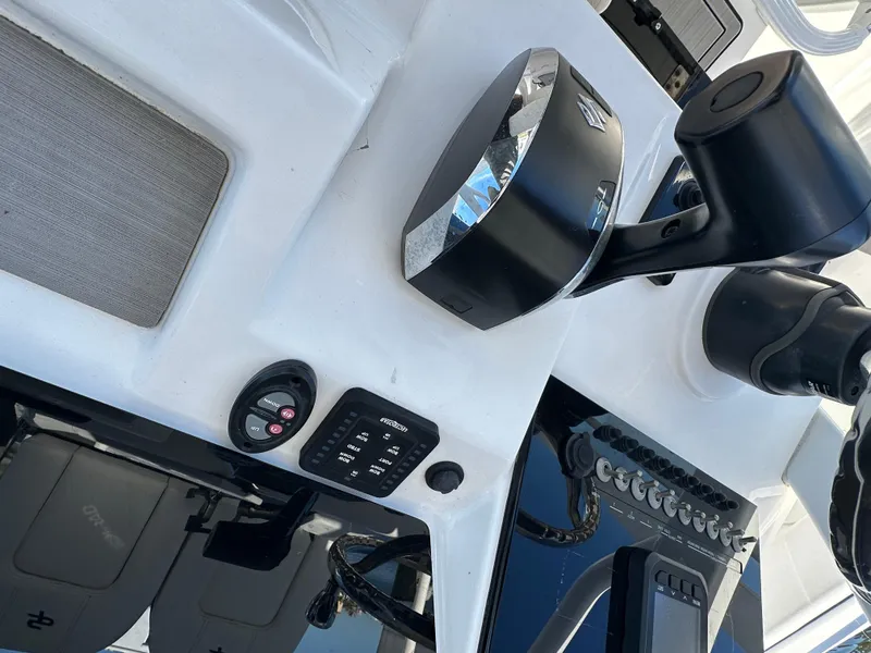 Slide: The Image of 2023 Sea Pro 239 Deep V CC boat dashboard with modern controls and navigation equipment. - 16