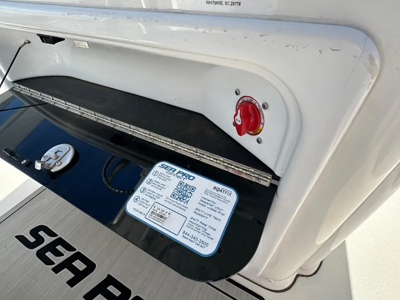 Slide: The Image of 2023 Sea Pro 239 Deep V CC boat compartment with safety label and red switch. - 19