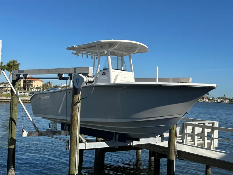 Slide: The Image of 2023 Sea Pro 239 Deep V CC boat on lift by waterfront. - 2