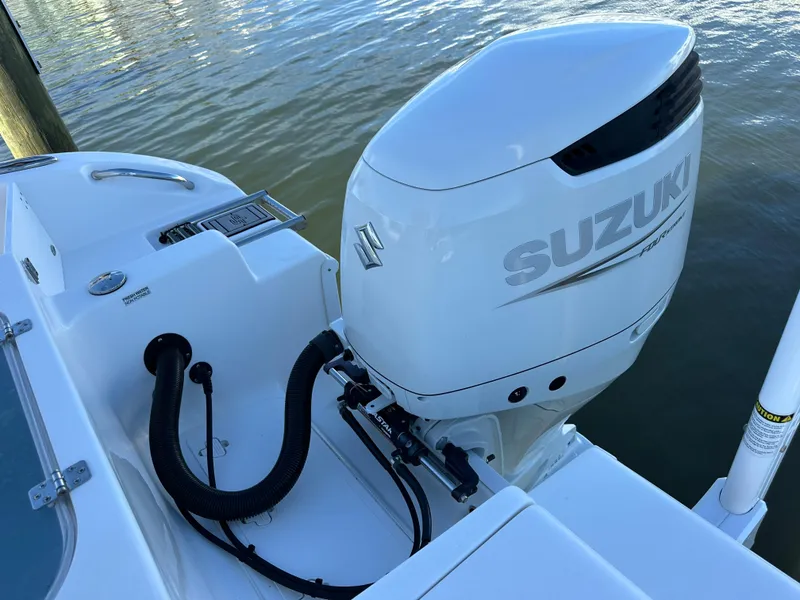 Slide: The Image of 2023 Sea Pro 239 Deep V CC with Suzuki outboard motor on water. - 22