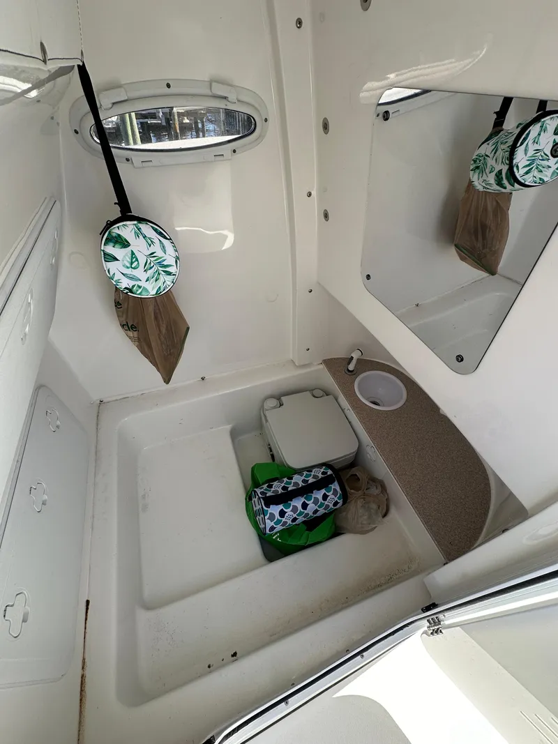 Slide: The Image of 2023 Sea Pro 239 Deep V CC boat interior with storage and amenities. - 24