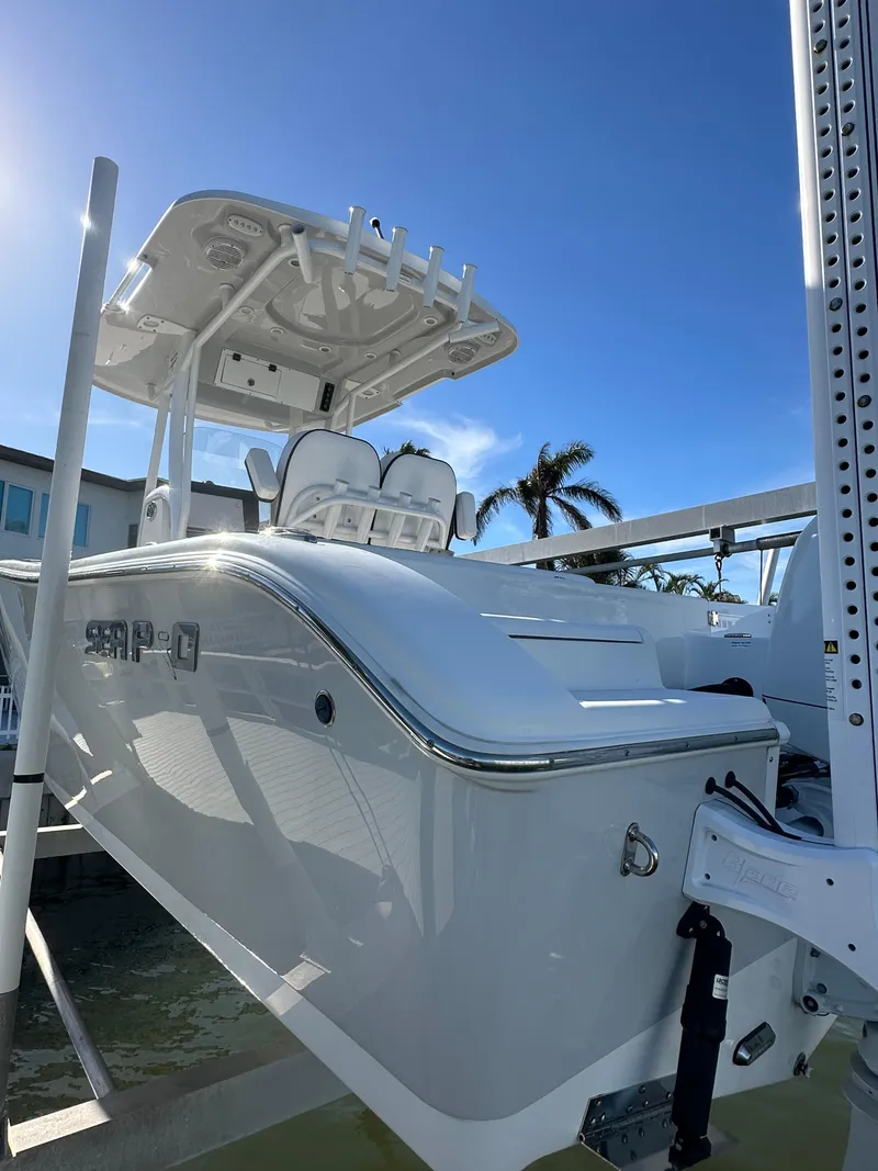 Slide: The Image of 2023 Sea Pro 239 Deep V CC boat on lift under clear blue sky. - 31