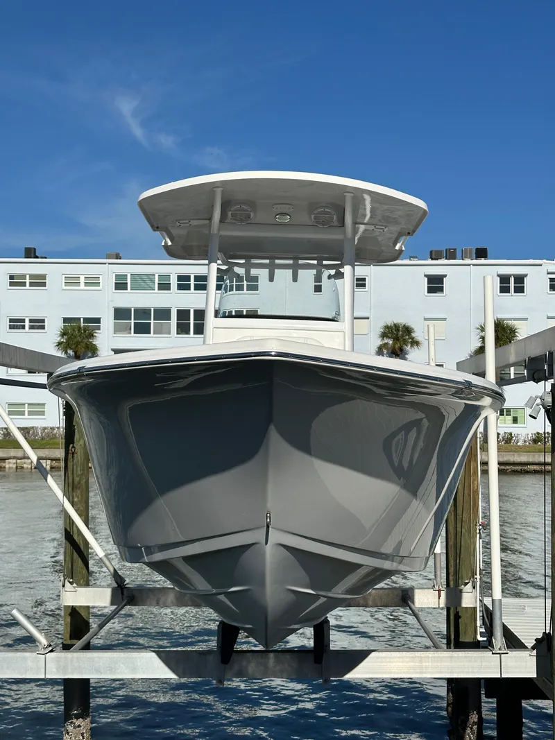 Slide: The Image of 2023 Sea Pro 239 Deep V CC boat on lift, with waterfront view. - 33
