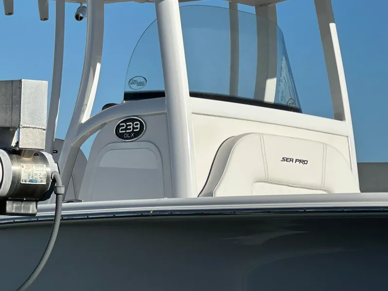 Slide: The Image of 2023 Sea Pro 239 Deep V CC boat, white console, clear blue sky background. - 6