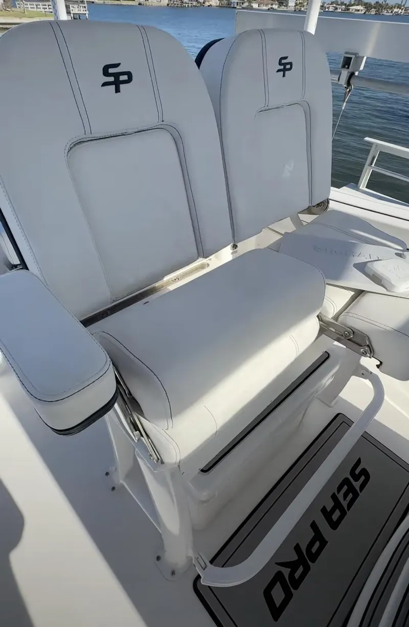 Slide: The Image of 2023 Sea Pro 239 Deep V CC boat seats with logo, featuring sleek white design. - 9