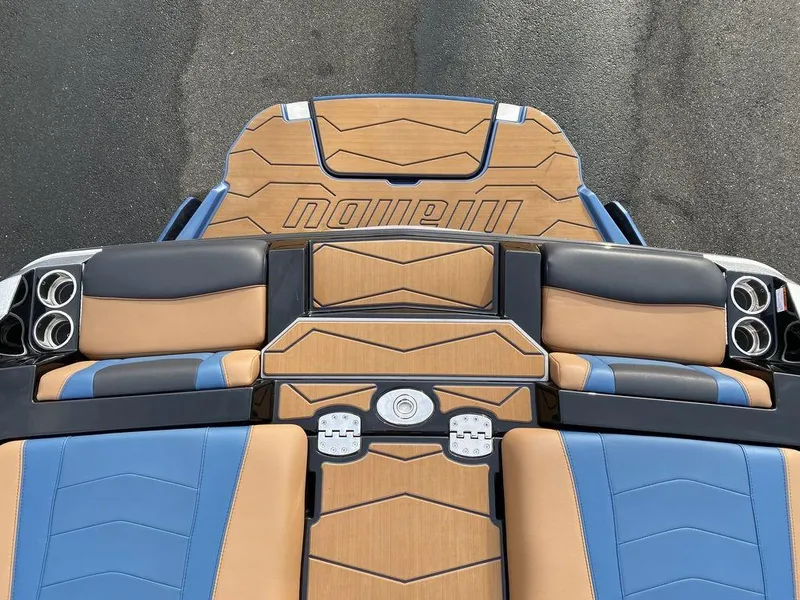 Slide: The Image of 2025 Malibu Wakesetter 22 MXZ boat interior with tan and black seating, stylish design. - 17