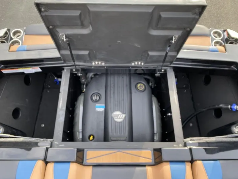 Slide: The Image of 2025 Malibu Wakesetter 22 MXZ interior with tan and blue seating, sleek dashboard, and modern controls. - 18