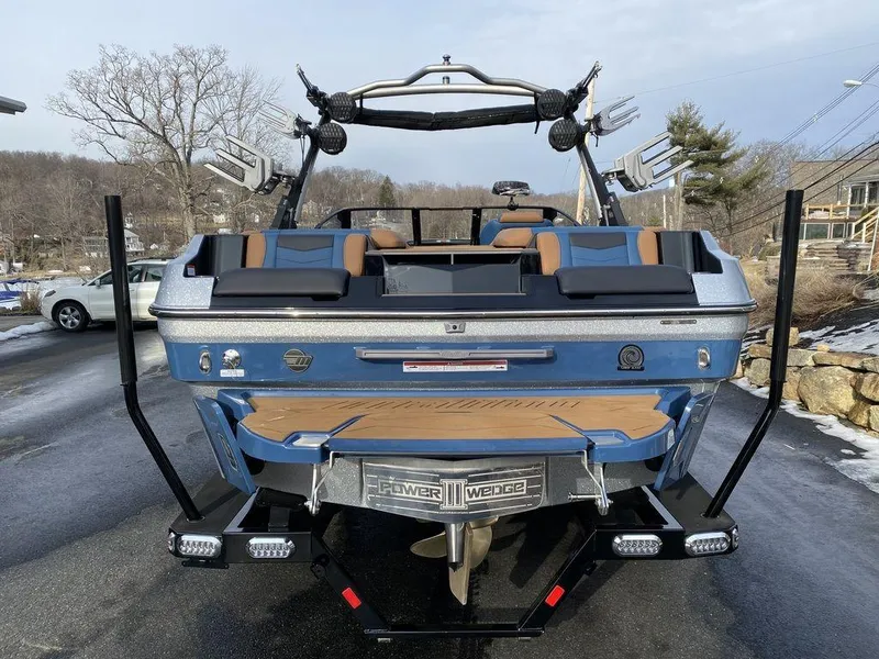 Slide: The Image of 2025 Malibu Wakesetter 22 MXZ boat on trailer at dealership. - 3