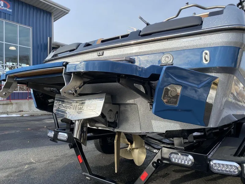 Slide: The Image of 2025 Malibu Wakesetter 22 MXZ boat on trailer, parked in residential area. - 5