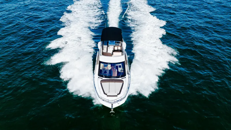 Slide: The Image of 2022 Galeon 400 Fly yacht cruising on open water, aerial view. - 11