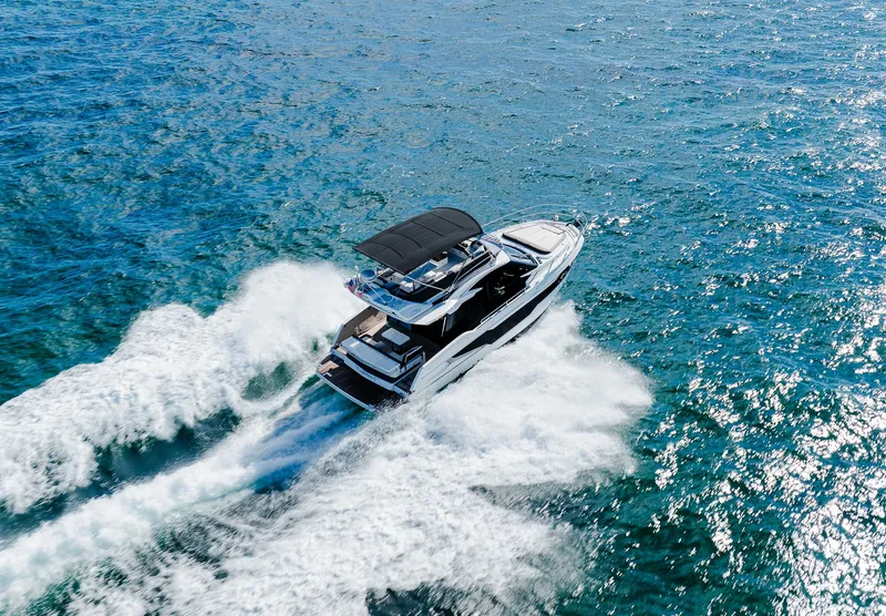 Slide: The Image of 2022 Galeon 400 Fly yacht cruising on open water. - 12
