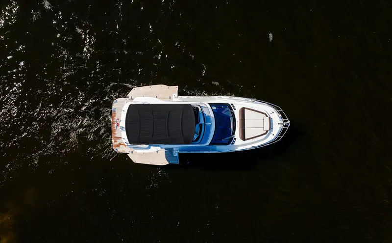 Slide: The Image of Aerial view of 2022 Galeon 400 Fly yacht on dark water. - 14