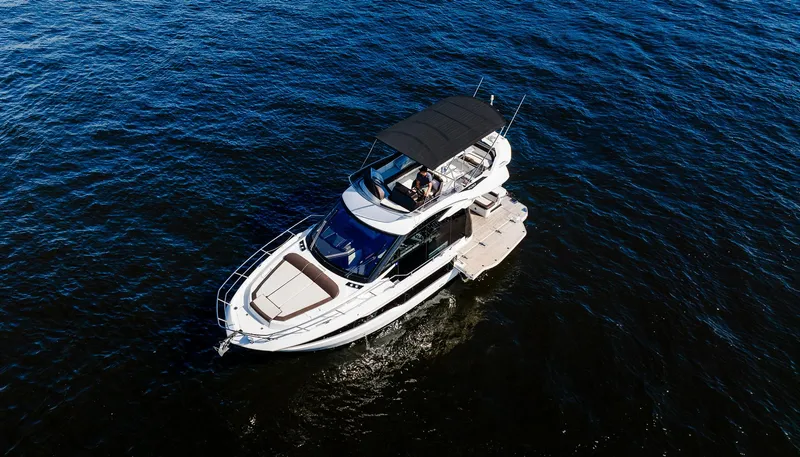 Slide: The Image of 2022 Galeon 400 Fly yacht cruising on open water. - 16