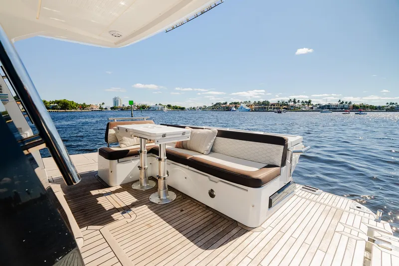 Slide: The Image of Galeon 400 Fly 2022 yacht deck with seating area overlooking serene waters. - 18