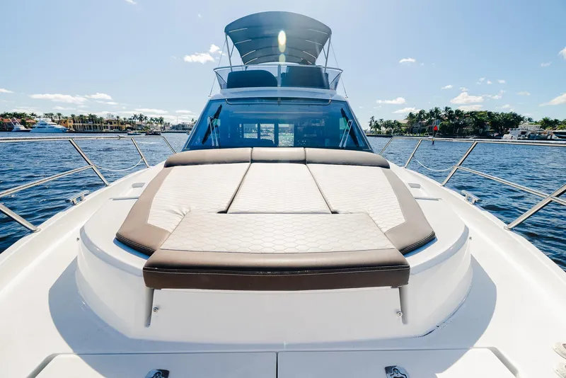 Slide: The Image of 2022 Galeon 400 Fly yacht on sunny water, featuring spacious deck and luxurious seating. - 21