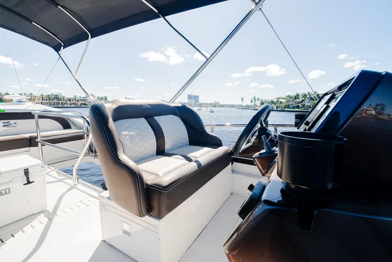 Slide: The Image of Galeon 400 Fly 2022 yacht helm with luxurious seating and scenic water view. - 24