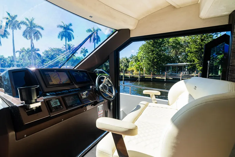 Slide: The Image of Interior of 2022 Galeon 400 Fly yacht with steering wheel and scenic water view. - 33