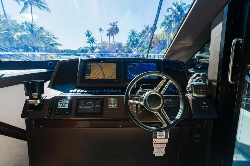Slide: The Image of Interior helm of 2022 Galeon 400 Fly yacht with navigation screens and steering wheel. - 34