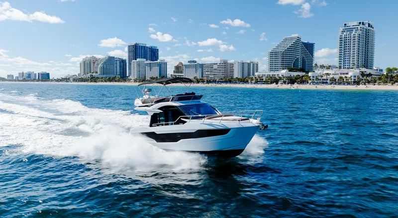 Slide: The Image of 2022 Galeon 400 Fly yacht cruising near city skyline on sunny day. - 5