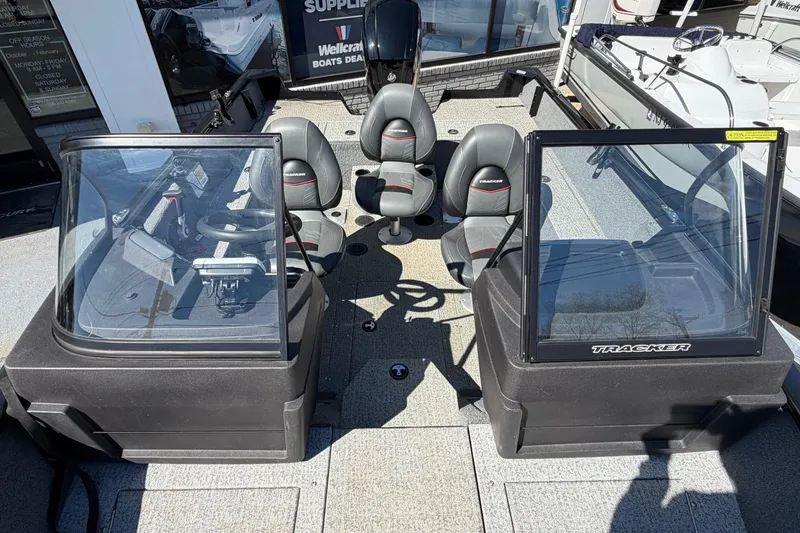 Slide: The Image of 2022 Tracker Pro Guide V-175 WT boat interior with seating and console view. - 14