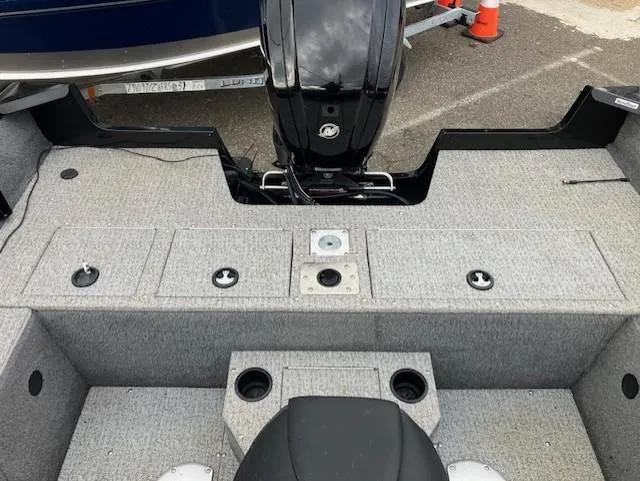 Slide: The Image of 2022 Tracker Pro Guide V-175 WT boat interior with motor and storage compartments. - 3