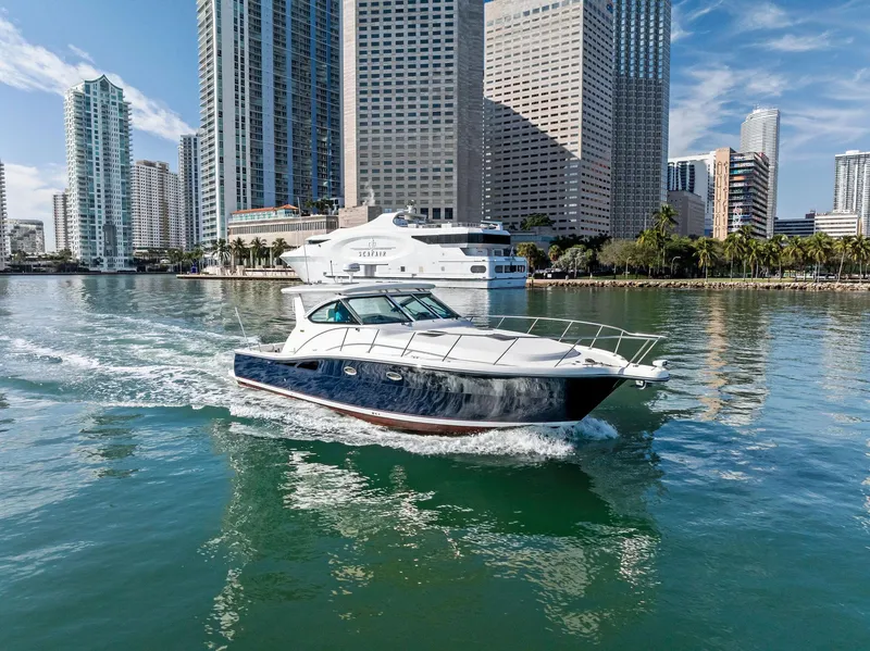 Slide: The Image of 2004 Tiara Yachts 4200 Open cruising near city skyline. - 0