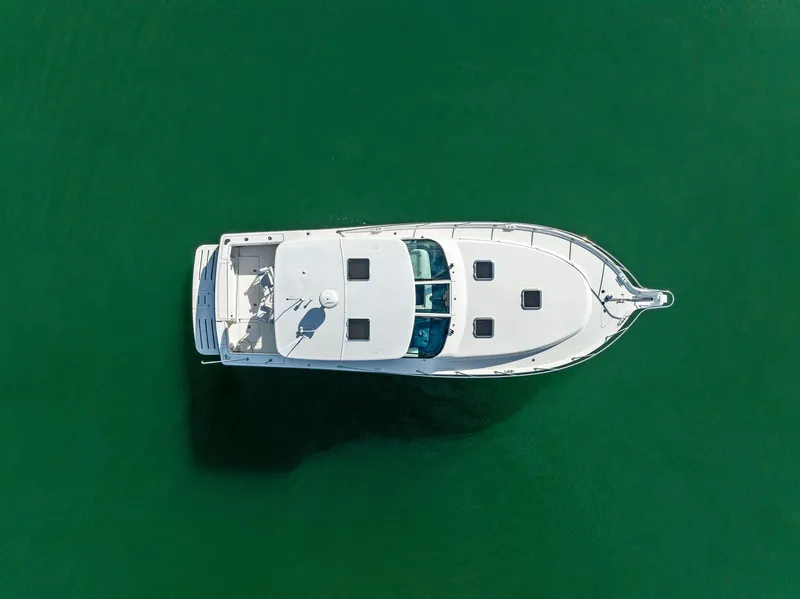 Slide: The Image of Aerial view of 2004 Tiara Yachts 4200 Open on green water. - 10