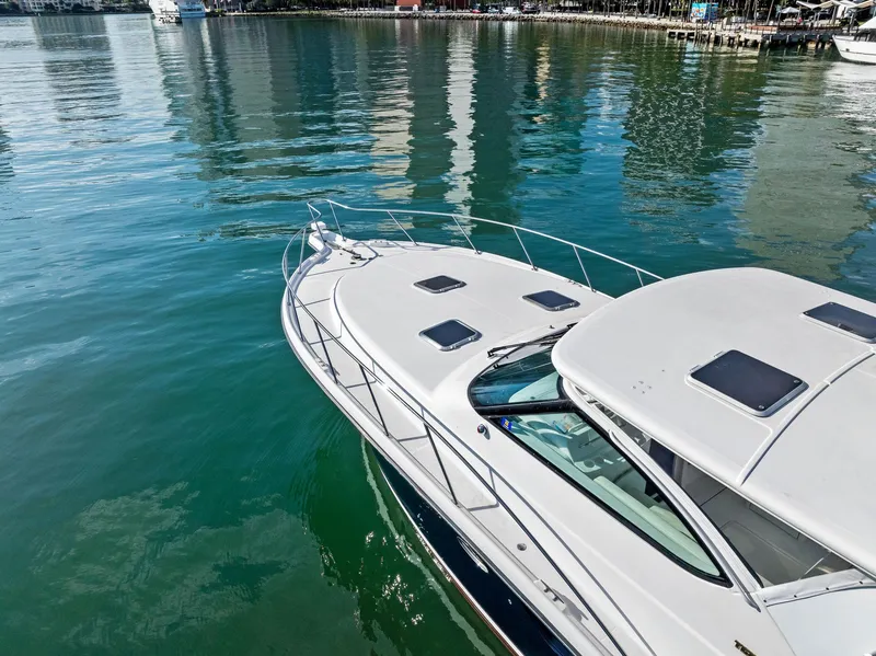 Slide: The Image of 2004 Tiara Yachts 4200 Open on calm water, showcasing sleek design and spacious deck. - 11