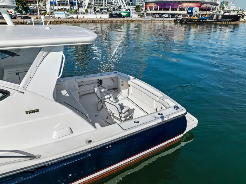 Slide: The Image of 2004 Tiara Yachts 4200 Open docked, featuring spacious deck and sleek design. - 12