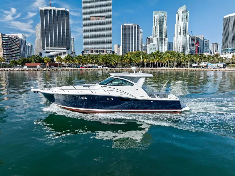 Slide: The Image of 2004 Tiara Yachts 4200 Open cruising near city skyline. - 13