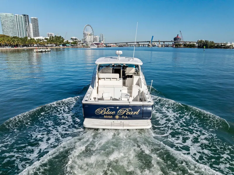 Slide: The Image of 2004 Tiara Yachts 4200 Open cruising in Miami waters, scenic city backdrop. - 17