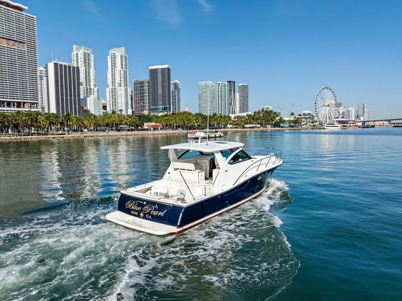 Slide: The Image of Tiara Yachts 4200 Open cruising near city skyline and Ferris wheel, 2004 model. - 18