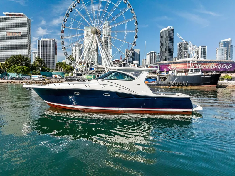 Slide: The Image of 2004 Tiara Yachts 4200 Open in urban marina with Ferris wheel and skyscrapers. - 2